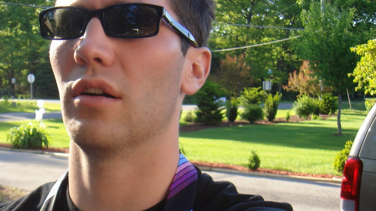 Chris Fischer wearing sunglasses and a striped tie outside during a Chicago wedding weekend in May 2006
