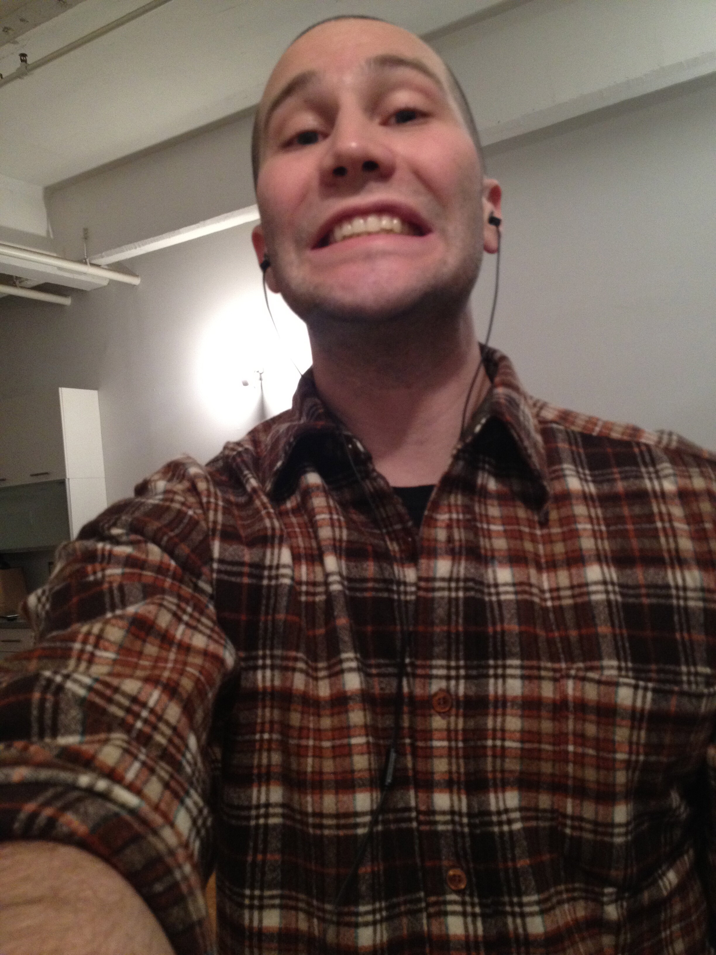 Chris Fischer grins in a vintage flannel while unpacking his new Williamsburg loft