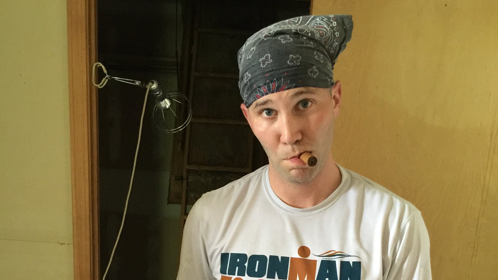 Chris Fischer wearing a dark bandana and white Ironman shirt during the July 2015 DeMotte house rebuild