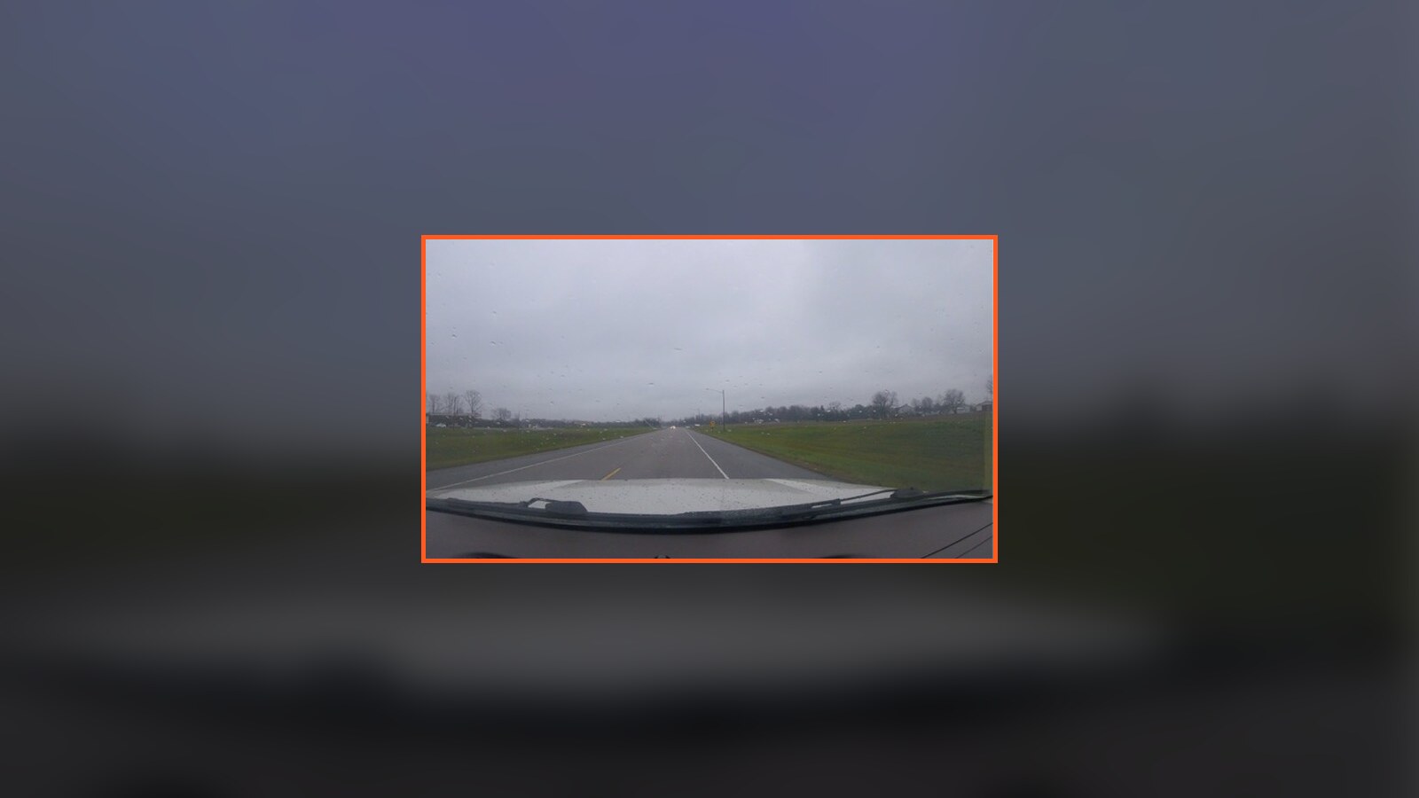 A wet rural road seen through the windshield during Chris Fischer's November 2015 mobile-home-park trip