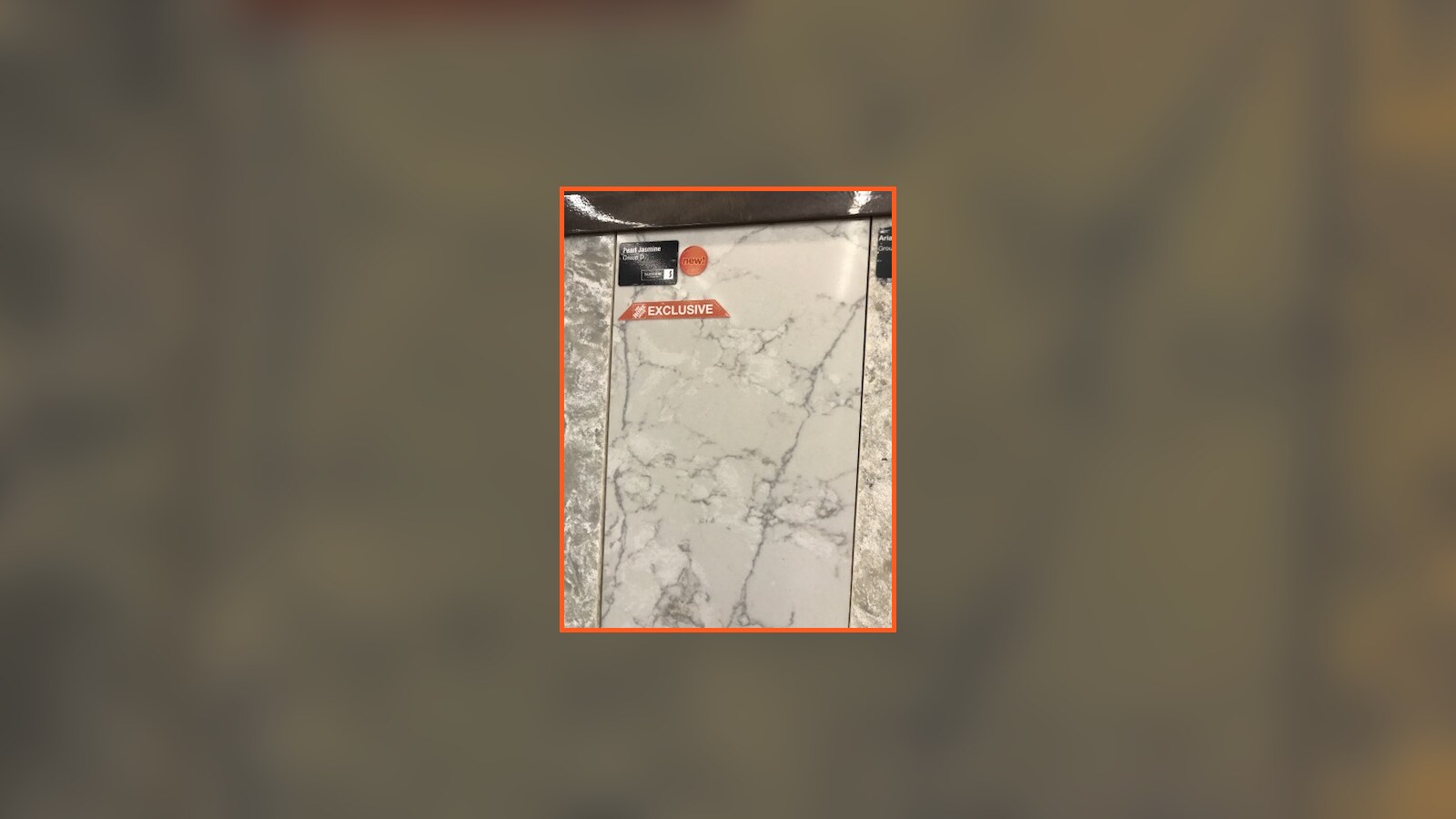 A white stone tile sample photographed while shopping for the Poughkeepsie bathroom