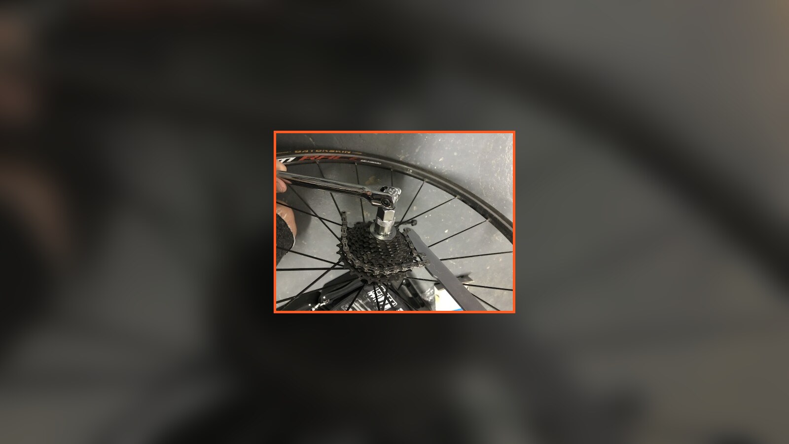 A socket wrench removing the cassette from Chris Fischer's rear bicycle wheel
