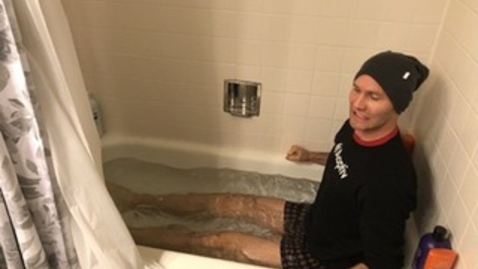 Chris Fischer sitting in a hotel bathtub full of ice after the 2018 Chicago Marathon