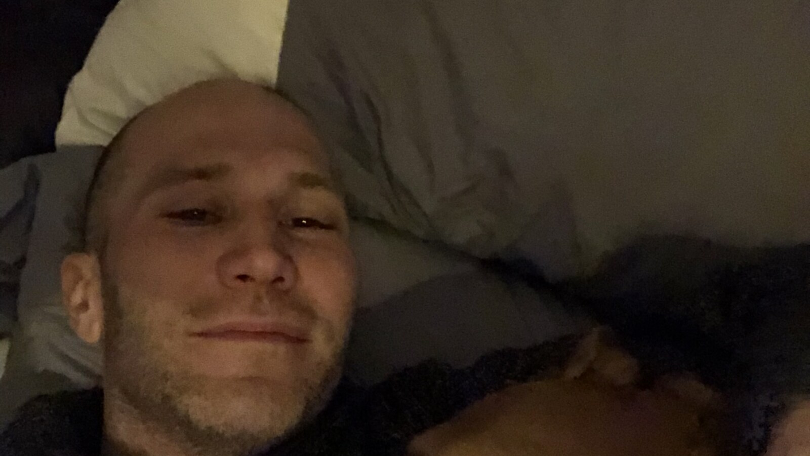 Chris Fischer lying on the couch with Eva after a 50K training run in the Hudson Valley