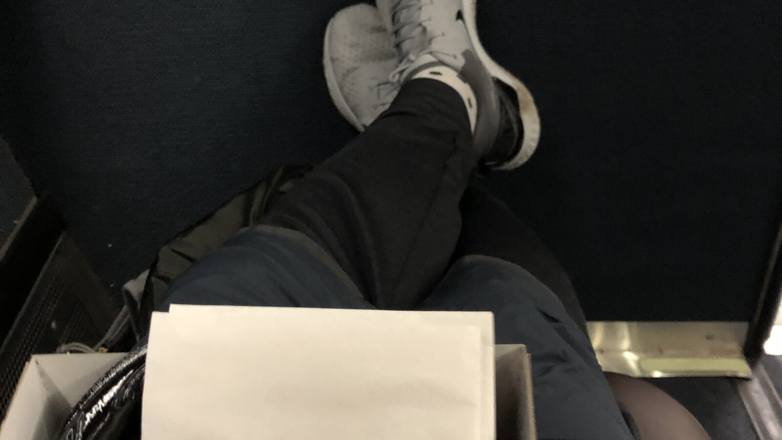 Chris Fischer's running shoes and crossed legs photographed on the evening of the 2019 Rock The Ridge 50-miler