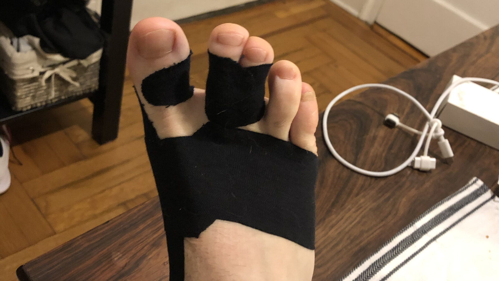 Chris's right forefoot wrapped in black athletic tape before the MRI result