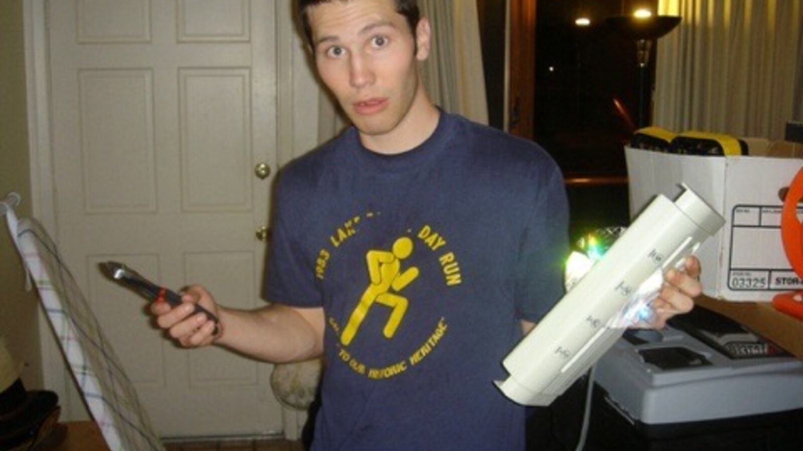A young Chris holding pliers and a bundle of parts in a 2004 personal archive photograph