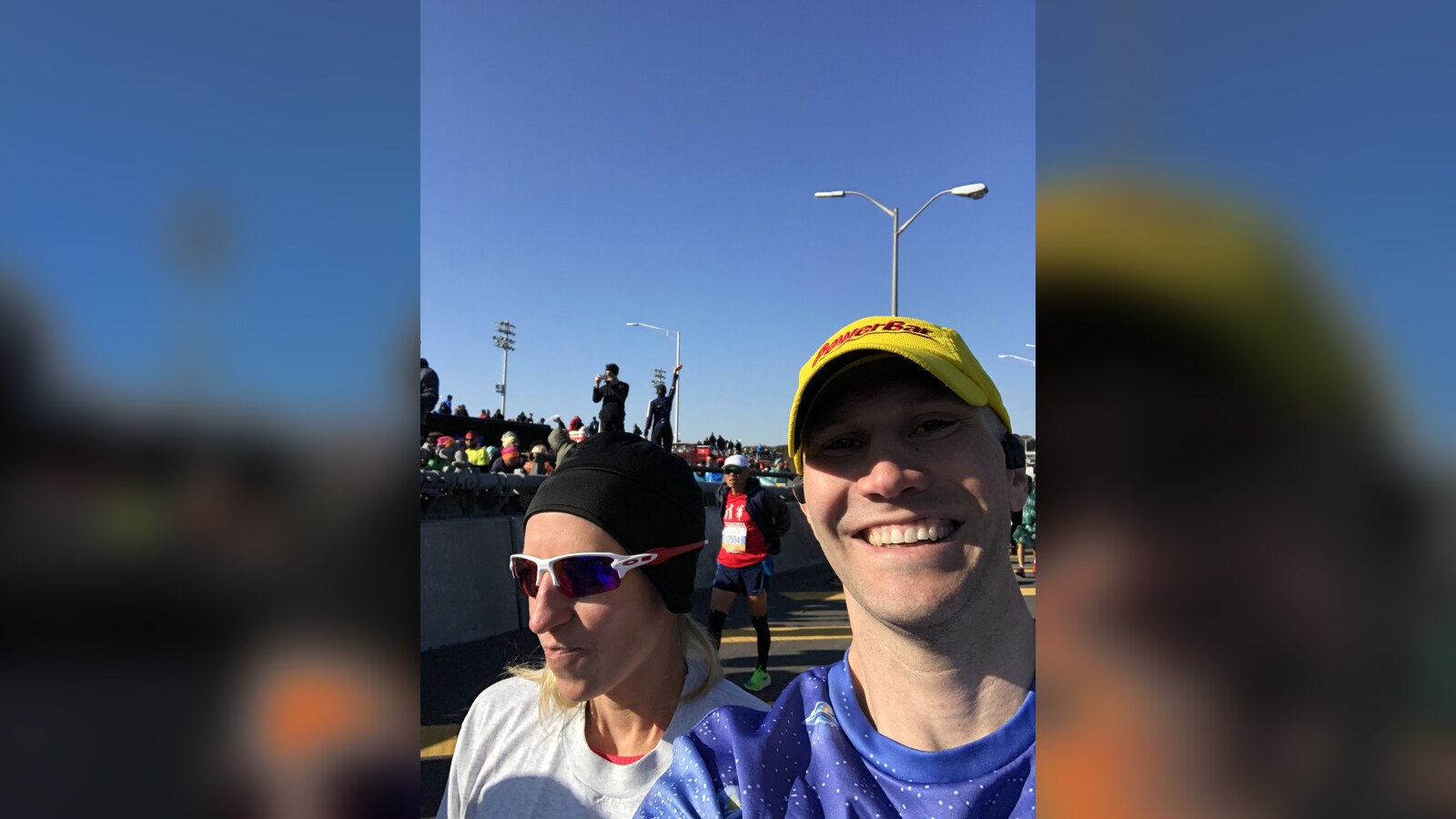 Chris taking a race-day selfie beside a friend on the 2019 New York City Marathon course