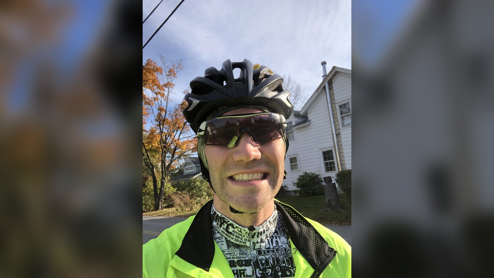 Chris smiling in a cycling helmet and sunglasses in a late-2019 personal archive photograph
