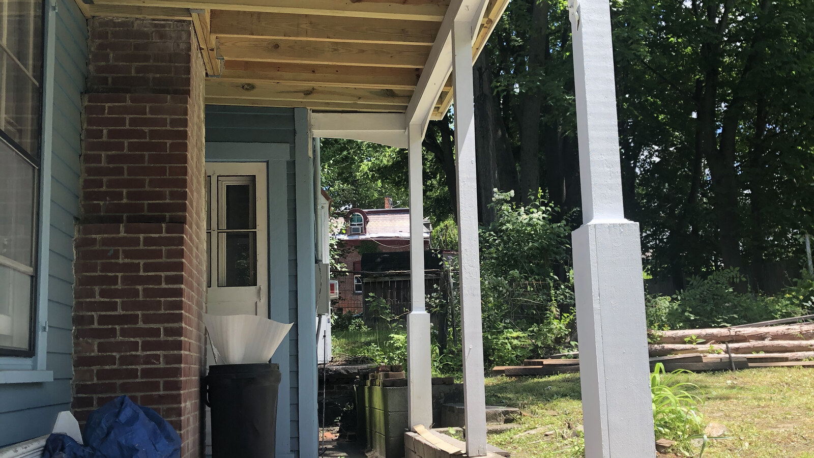 Fresh lumber under the porch roof of Chris's old Poughkeepsie house during repairs in May 2020