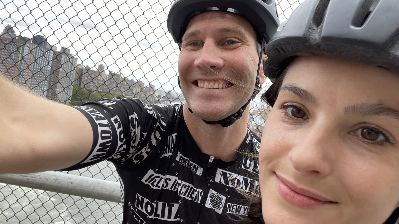 Chris and Amanda smiling in cycling helmets during a New York ride in August 2021