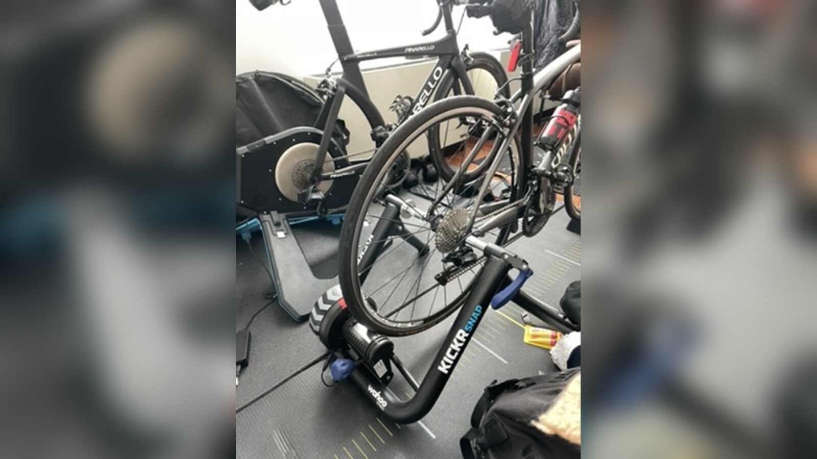 Two black race bikes set up on indoor trainers during a week of travel planning