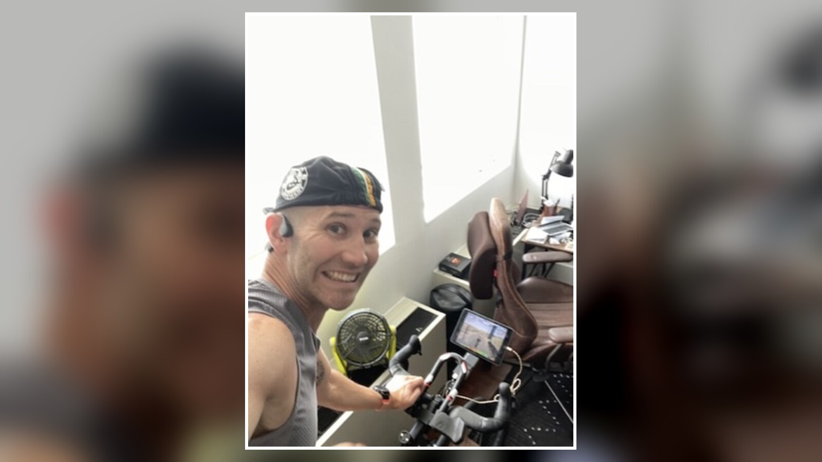 Chris grinning beside an indoor bike after a packed Wahoo work week