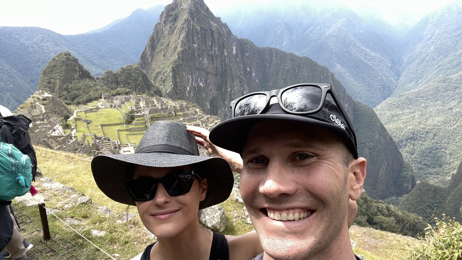 Chris and Amanda smiling together with Machu Picchu behind them
