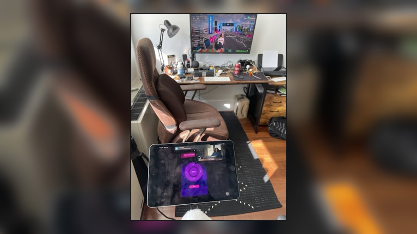RGT running on a television and SYSTM open on a tablet in Chris's crowded home office
