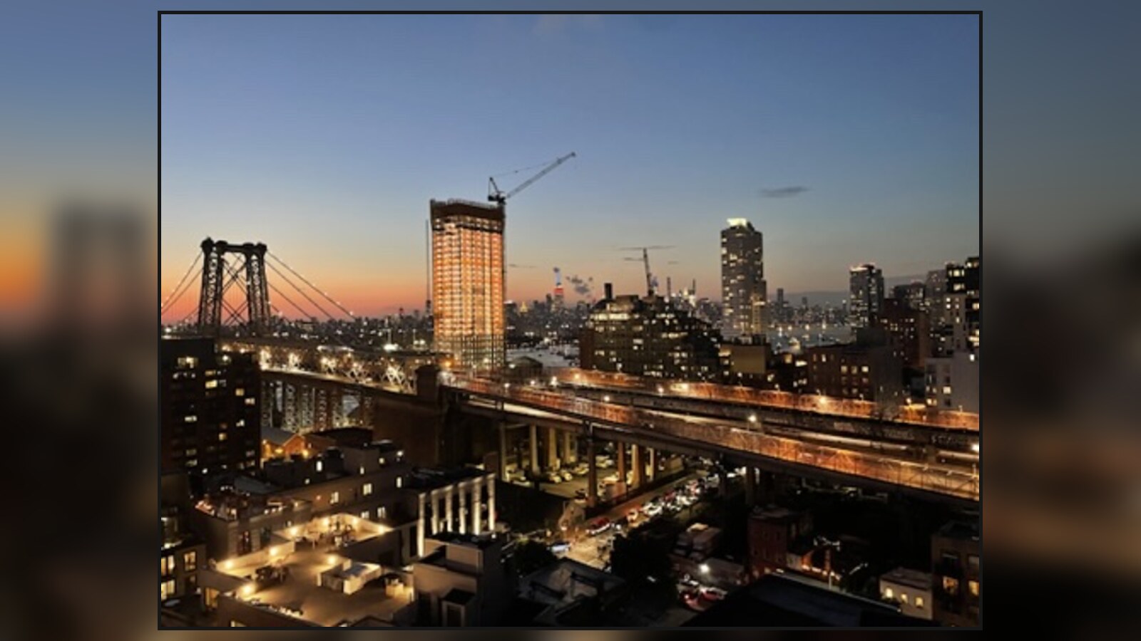 The Williamsburg Bridge and Manhattan skyline at dusk from Chris's Brooklyn loft