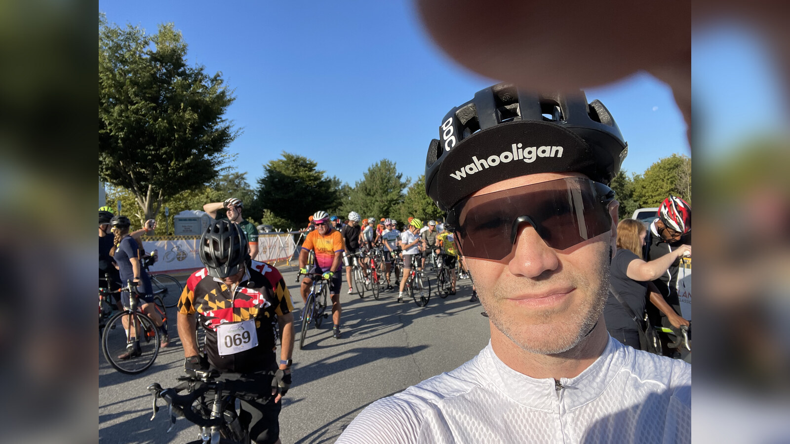 Chris wearing a Wahooligan cycling cap and helmet before a large group ride