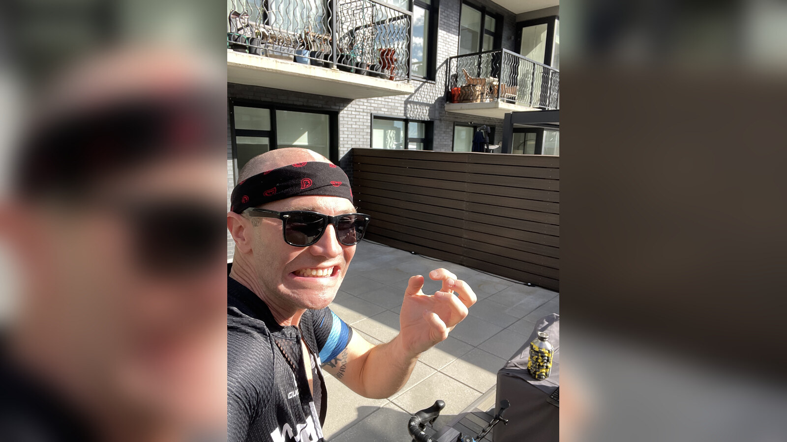 Chris smiling on the terrace of his new place in Rockaway after a bike ride