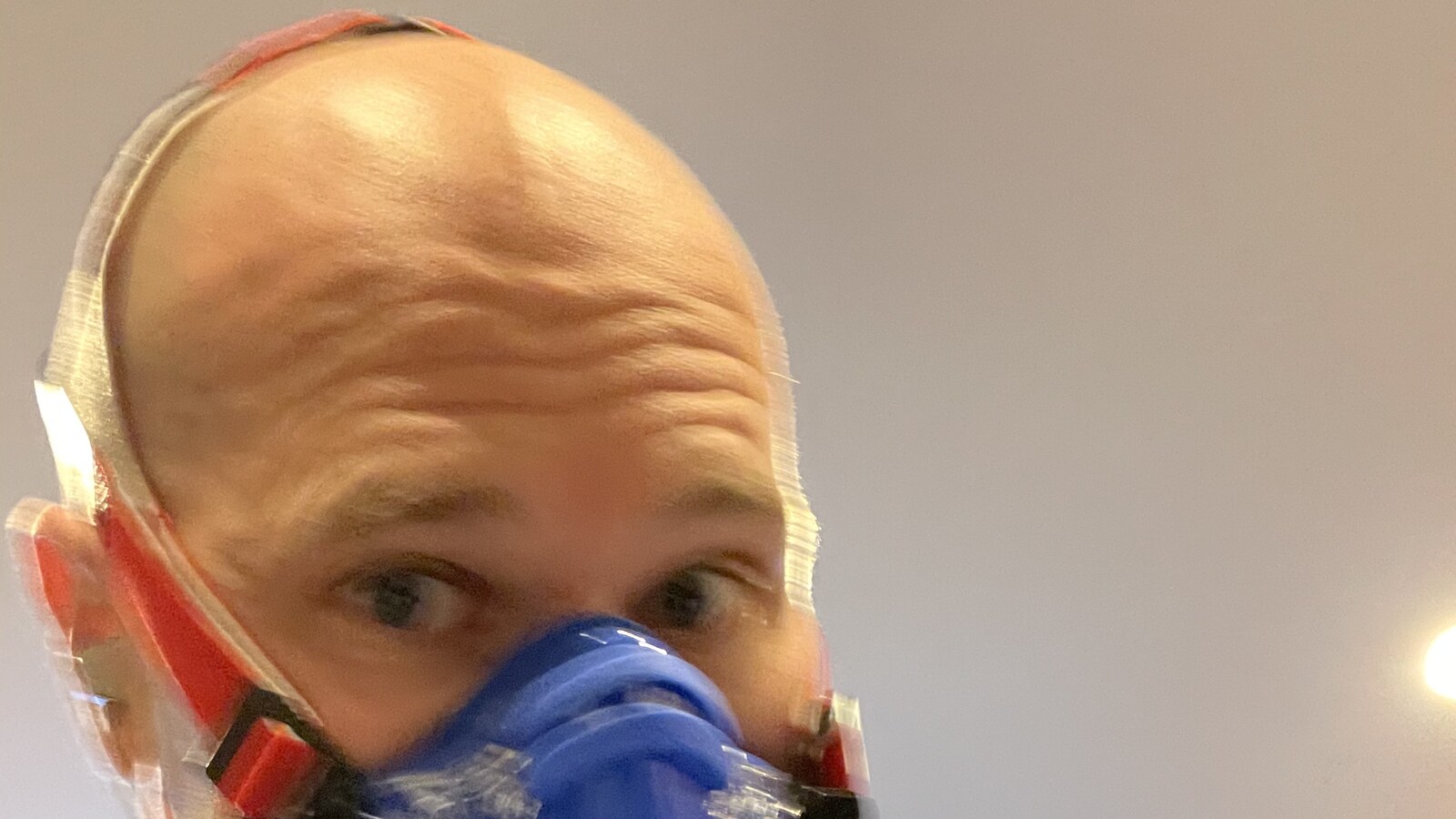 Chris wearing a blue respiratory mask during a performance test in Boston