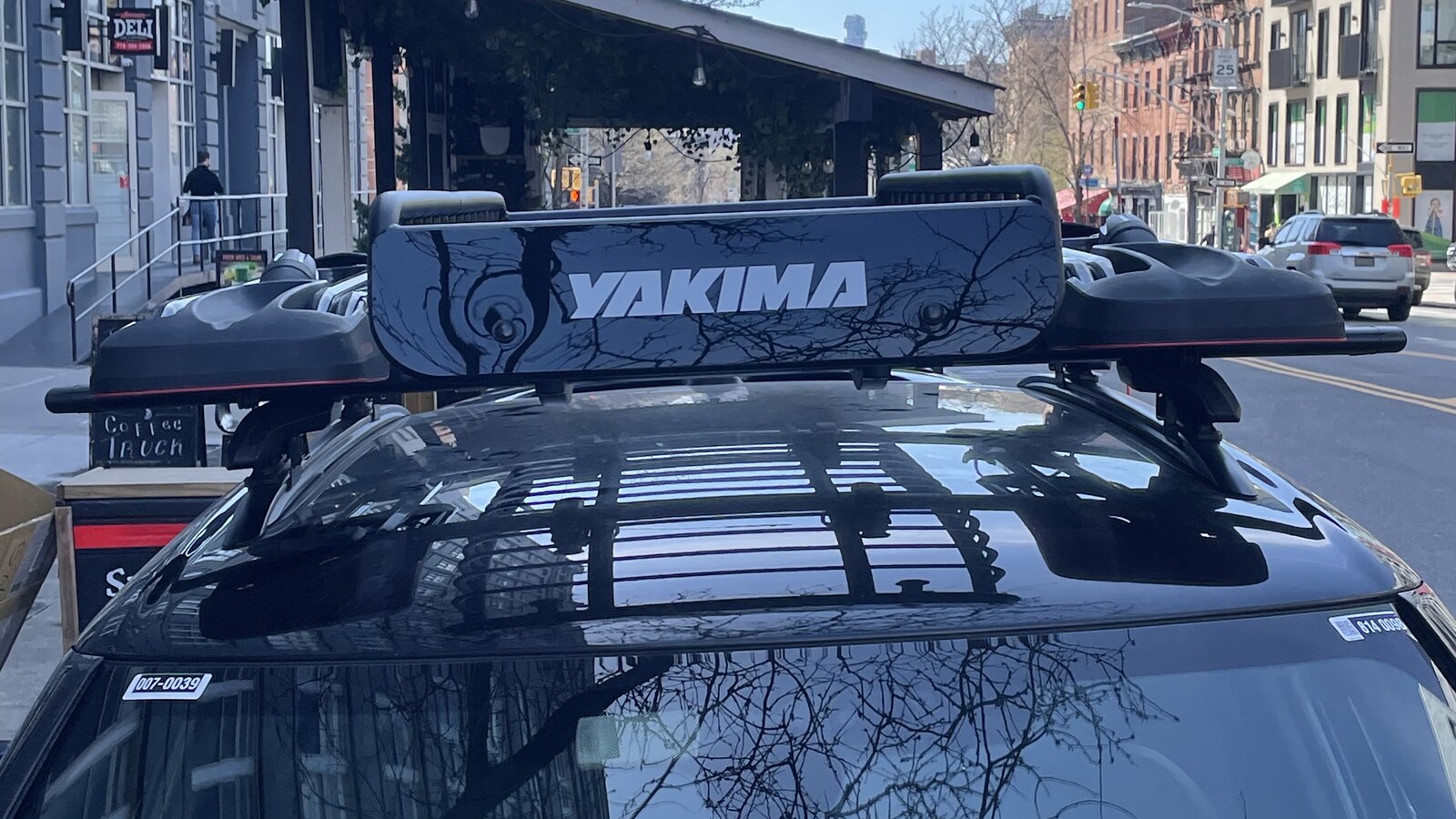 A black Yakima cargo cage mounted on the roof of Chris's Mini in Williamsburg