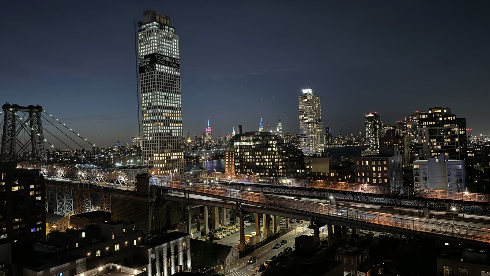 The Williamsburg Bridge and Manhattan skyline at night from Chris's apartment
