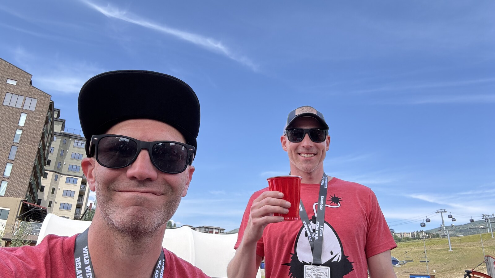 Chris and a teammate wearing Wild West Relay medals at the finish in Steamboat Springs